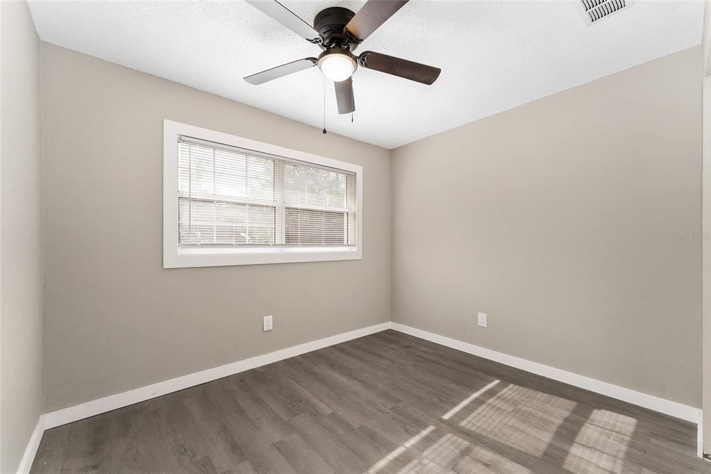 919 Southeast 19th Street Gainesville, FL 32641 - Photo 26 of 50 a view of an empty room with a window and wooden floor