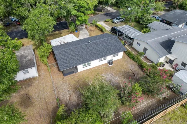 an aerial view of a house with garden space and street view