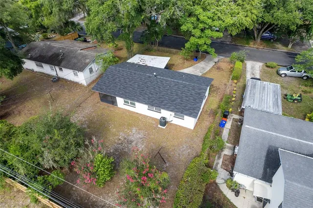 an aerial view of a house with outdoor space and lake view