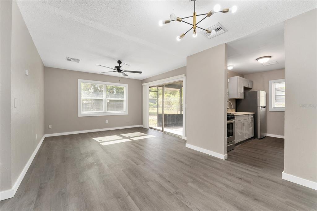 919 Southeast 19th Street Gainesville, FL 32641 - Photo 7 of 50 a view of an empty room with wooden floor and a window