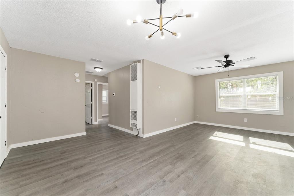 919 Southeast 19th Street Gainesville, FL 32641 - Photo 10 of 50 a view of an empty room with a window and wooden floor