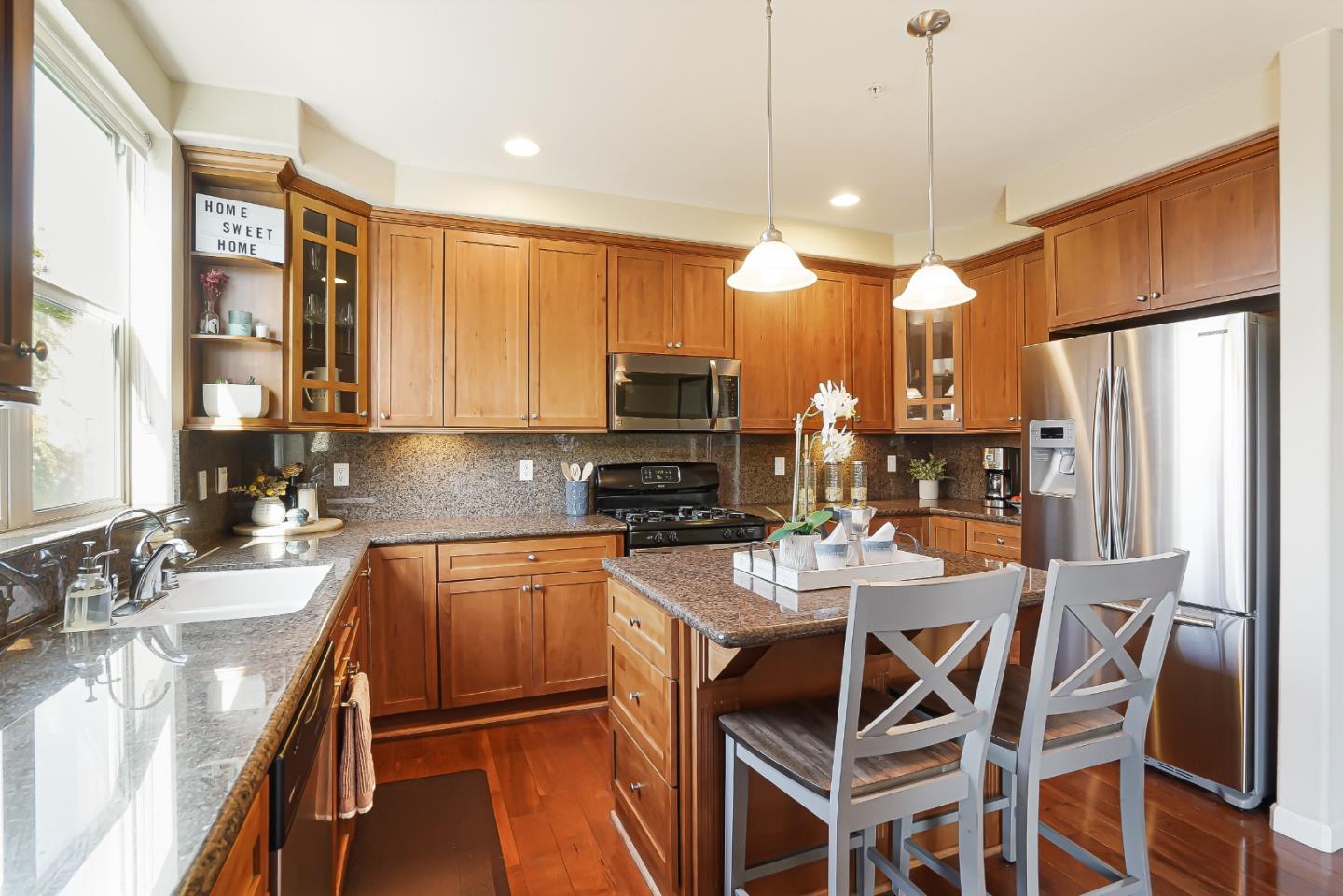 109 Esfahan Drive San Jose, CA 95111 - Photo 20 of 44 a kitchen with stainless steel appliances granite countertop a stove top oven a sink a stove a dining table and chairs