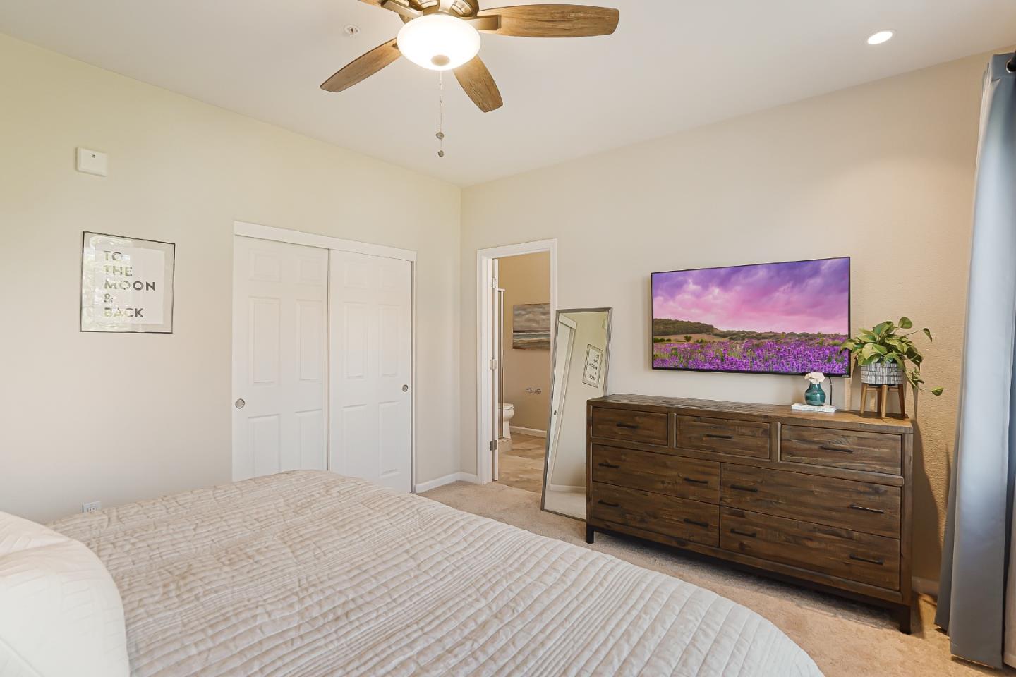 109 Esfahan Drive San Jose, CA 95111 - Photo 25 of 44 a bedroom with a bed and a chandelier