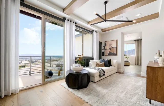 a living room with furniture and large windows