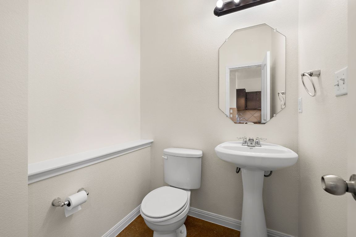 4602 Kind Way, Unit 287 Austin, TX 78725 - Photo 12 of 25 a bathroom with a toilet sink and mirror