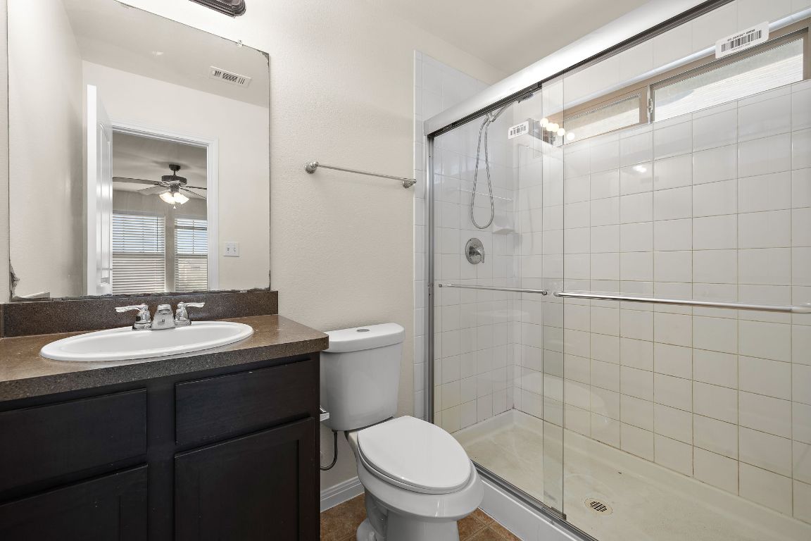 4602 Kind Way, Unit 287 Austin, TX 78725 - Photo 16 of 25 a bathroom with a granite countertop sink toilet and shower
