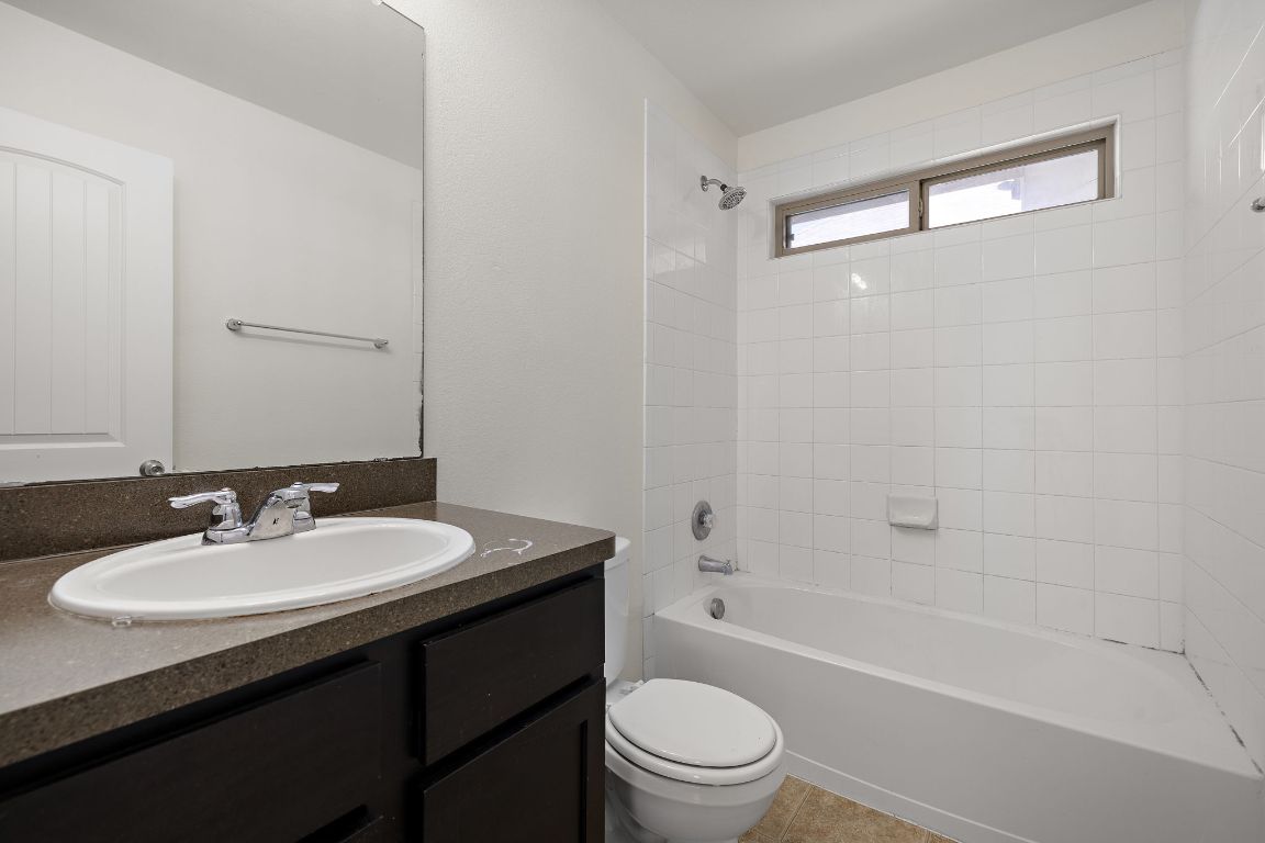 4602 Kind Way, Unit 287 Austin, TX 78725 - Photo 19 of 25 a bathroom with a sink a toilet a mirror and shower