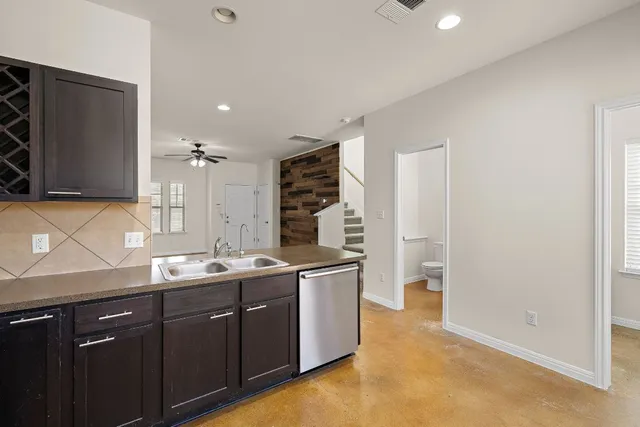 a kitchen with a sink and a refrigerator