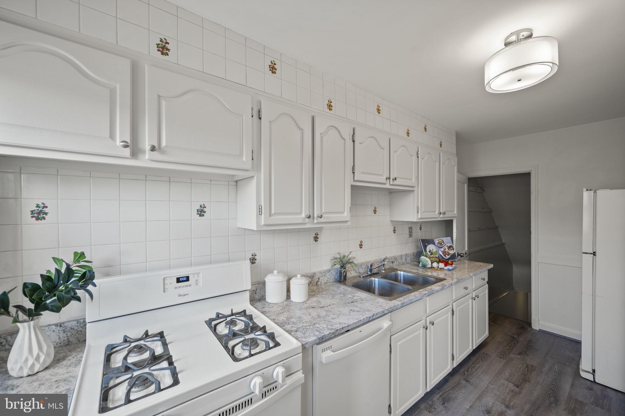 36 Darrow Drive Baltimore, MD 21228 - Photo 11 of 42 a kitchen with white cabinets and white appliances
