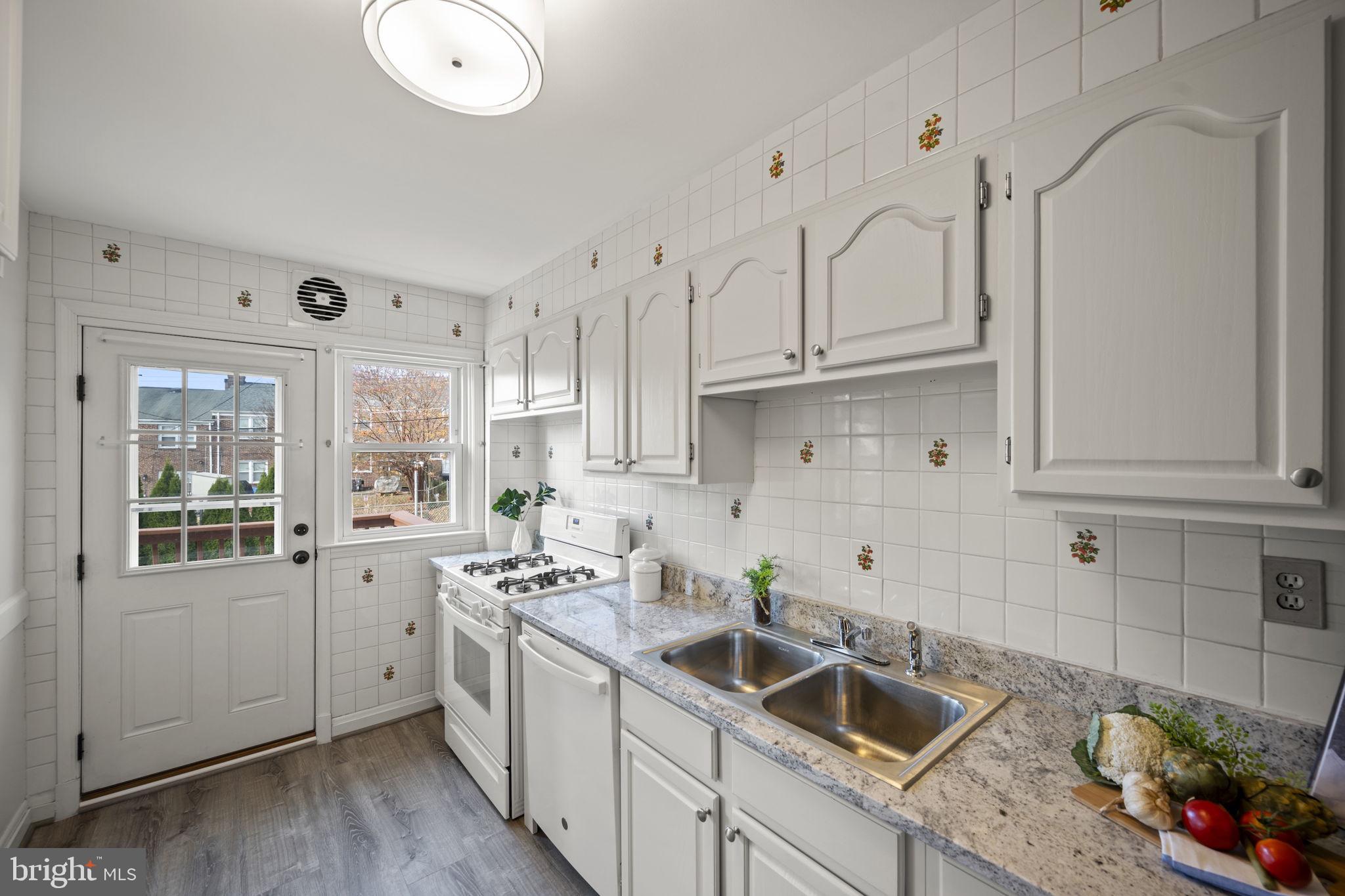 36 Darrow Drive Baltimore, MD 21228 - Photo 12 of 42 a kitchen that has a lot of cabinets in it and wooden floors
