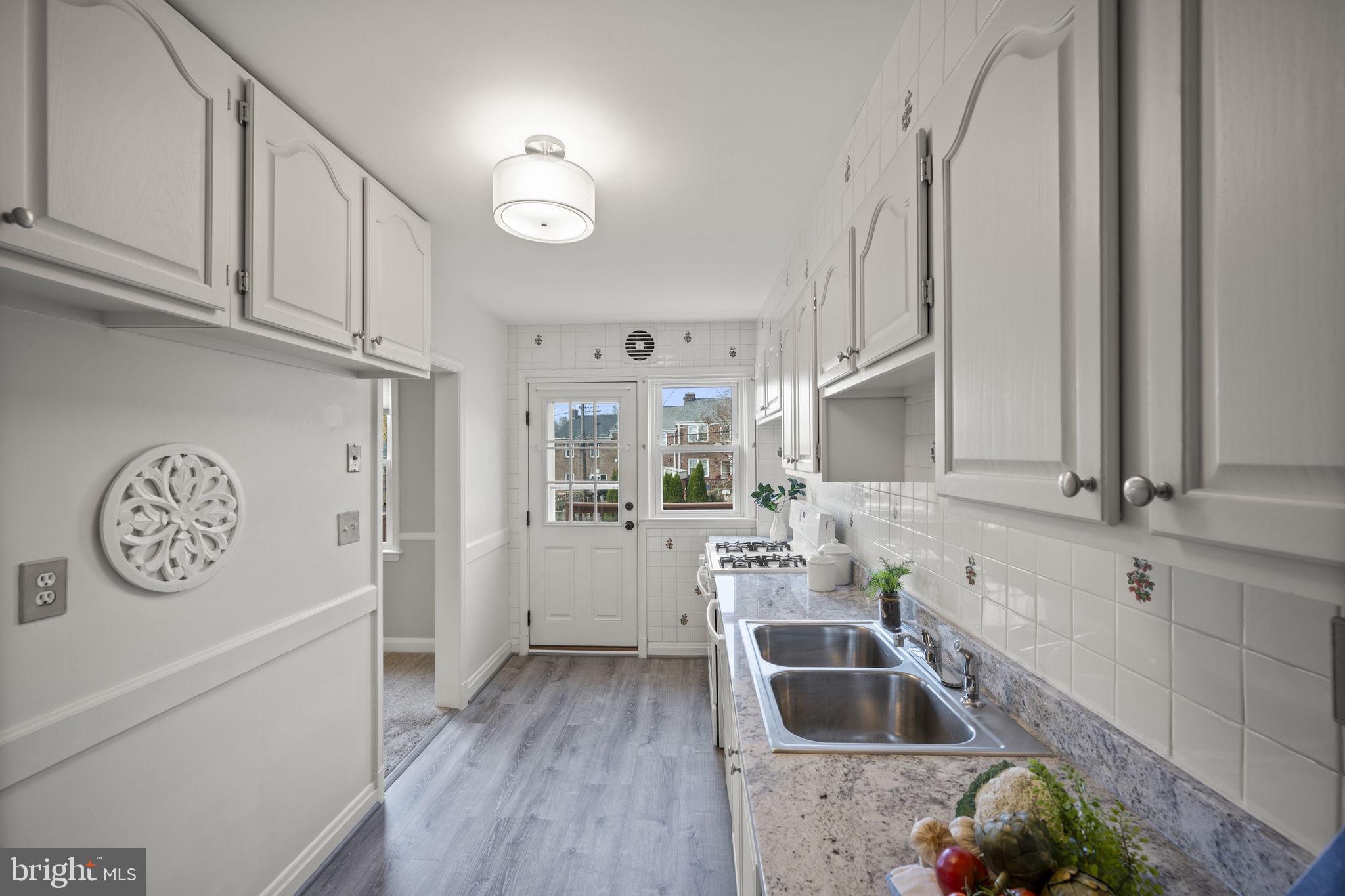 36 Darrow Drive Baltimore, MD 21228 - Photo 13 of 42 a bathroom with a bathtub sink and cabinets