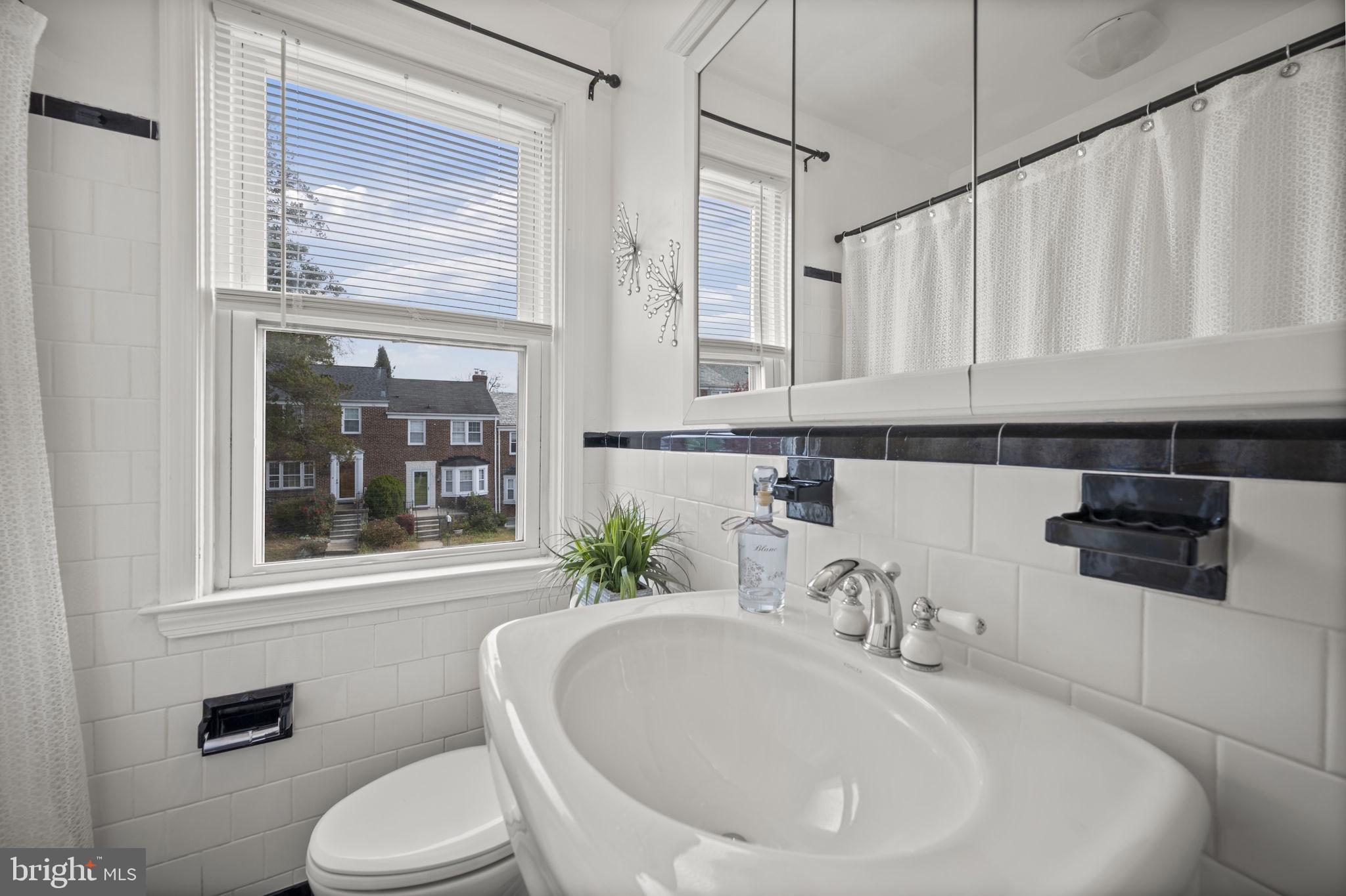 36 Darrow Drive Baltimore, MD 21228 - Photo 19 of 42 a bathroom with a sink a toilet and a mirror