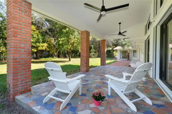 a view of a patio with a table chairs and backyard