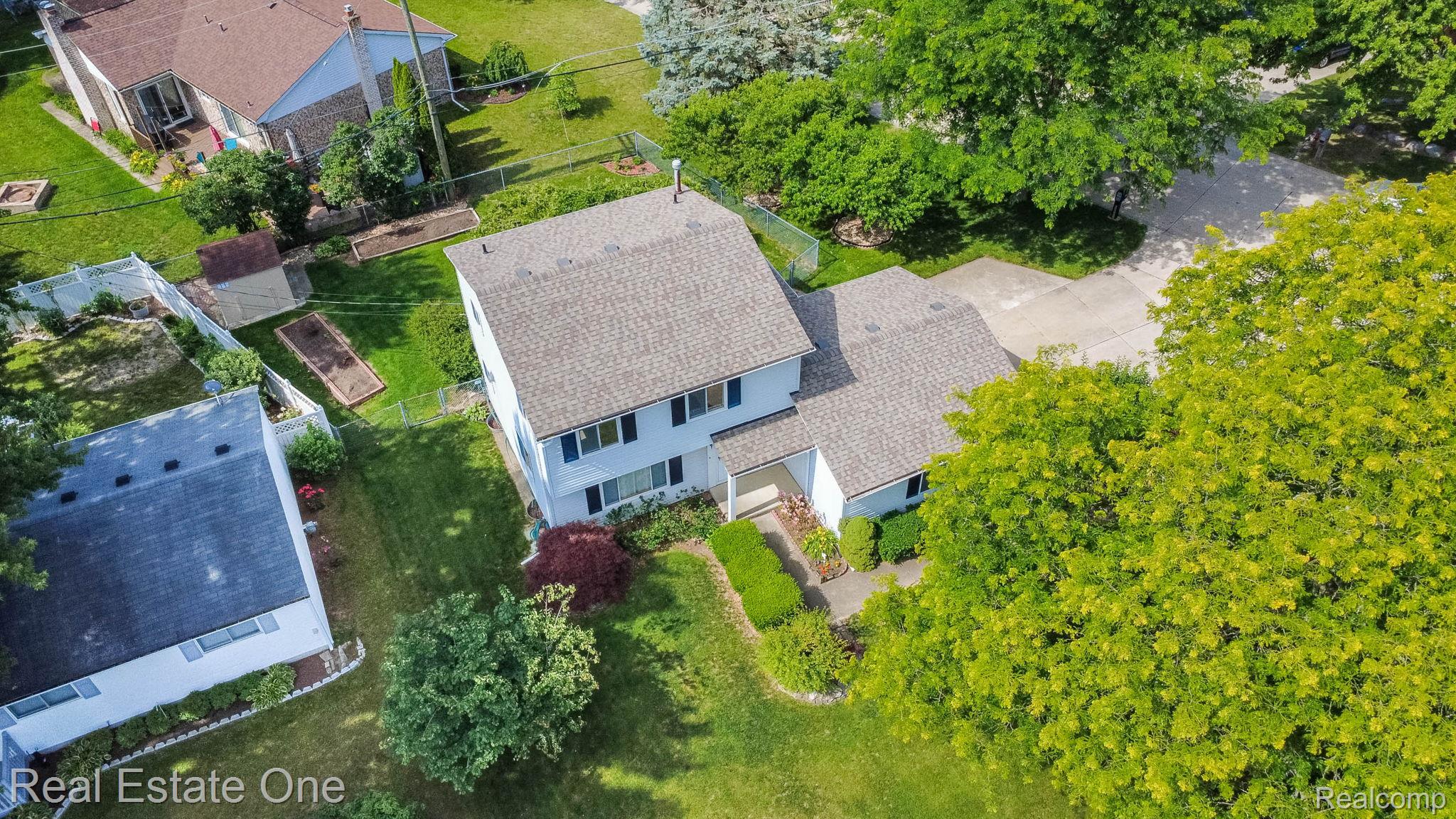 13912 Clinton River Road Sterling Heights, MI 48313 - Photo 36 of 43 Two-story residence featuring a shingled roof and light-toned siding