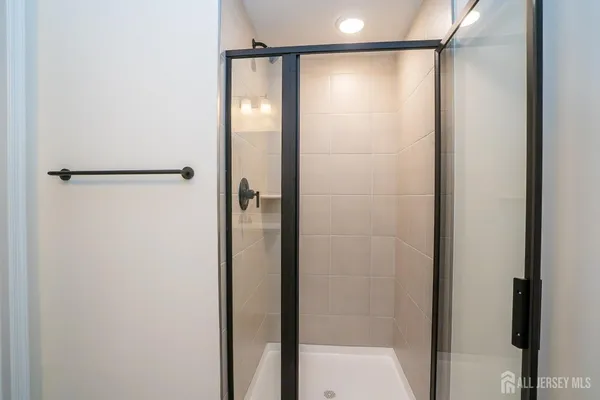 a bathroom with a glass shower door
