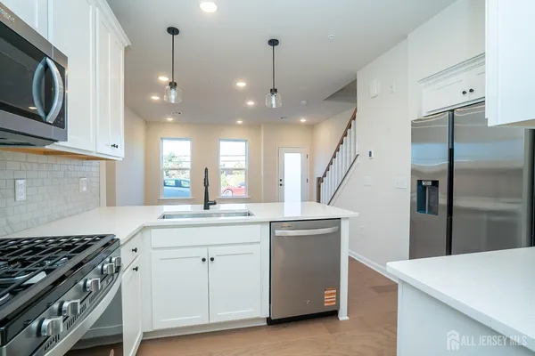 a kitchen with a sink stove and refrigerator