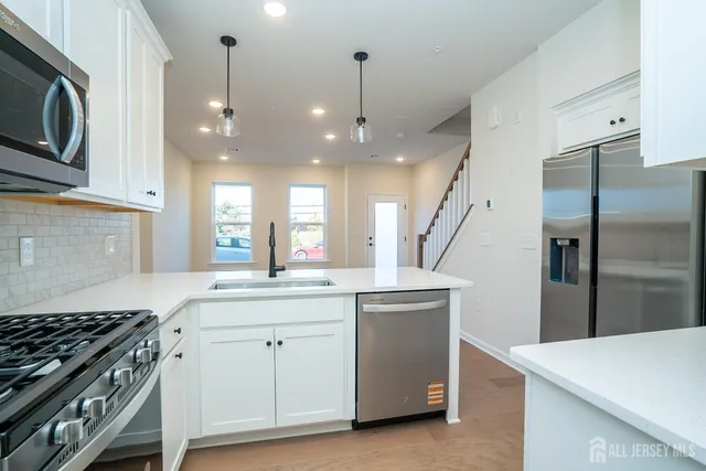 a kitchen with a sink stove and refrigerator