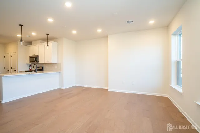 a view of kitchen with kitchen island and stainless steel appliances