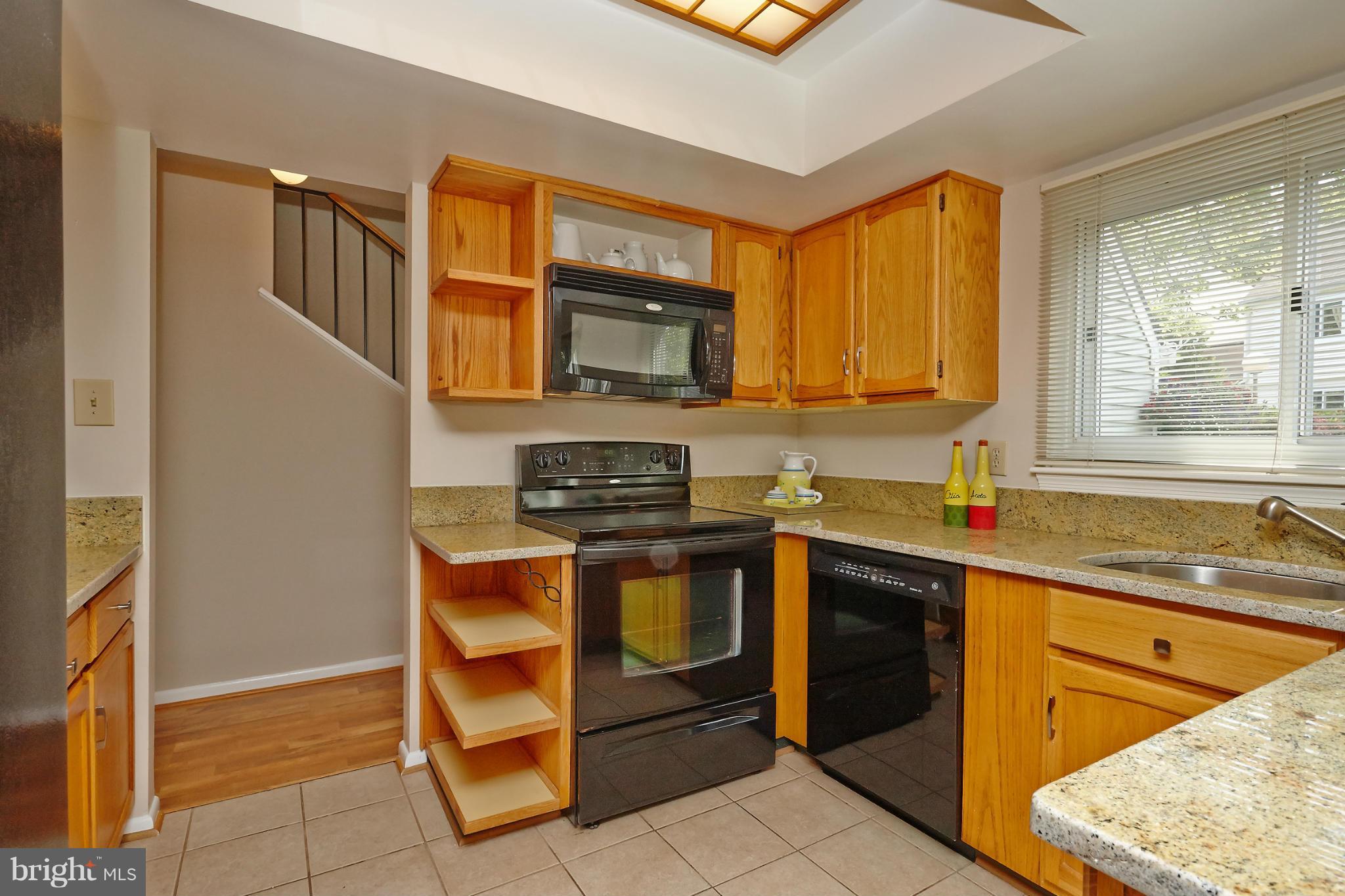 1426 Yellowwood Court Reston, VA 20190 - Photo 11 of 30 a kitchen with stainless steel appliances granite countertop a stove a sink and a microwave