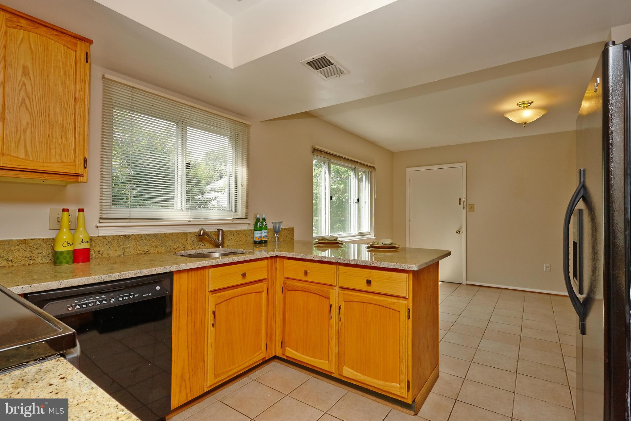 1426 Yellowwood Court Reston, VA 20190 - Photo 12 of 30 a kitchen with stainless steel appliances granite countertop a sink stove and refrigerator