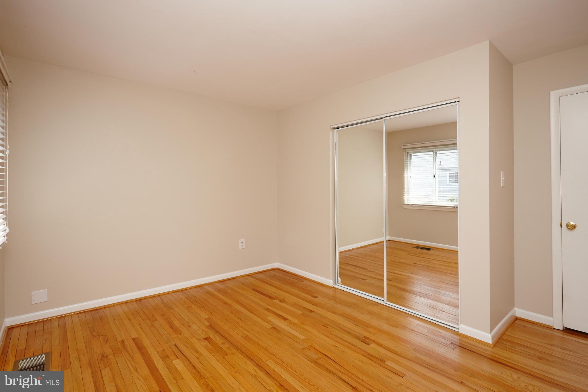 1426 Yellowwood Court Reston, VA 20190 - Photo 16 of 30 an empty room with wooden floor cabinet and front door