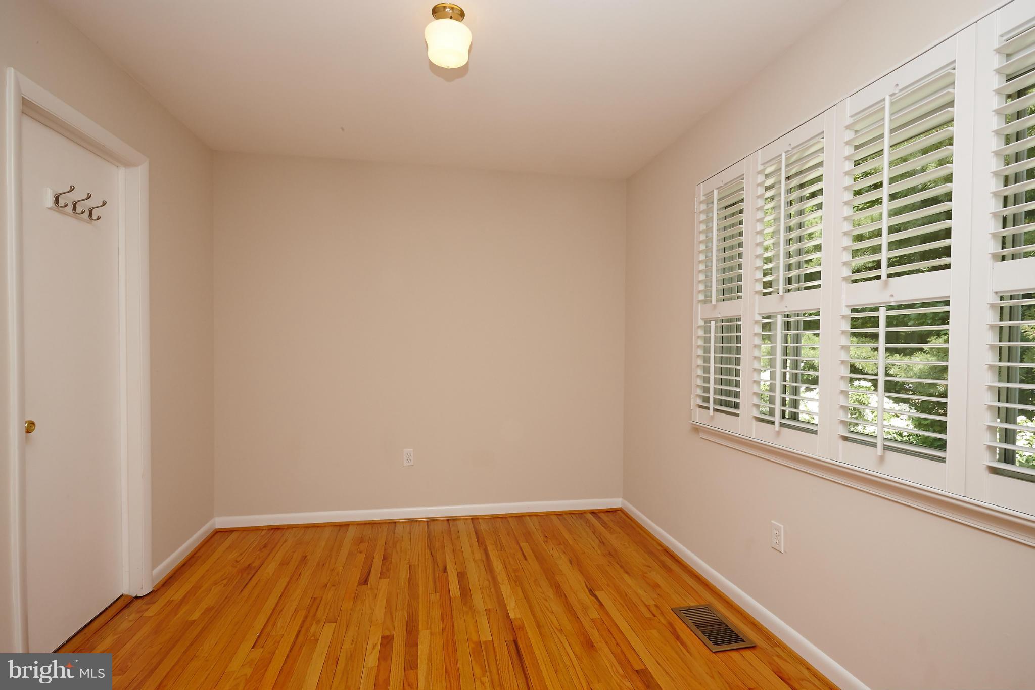 1426 Yellowwood Court Reston, VA 20190 - Photo 20 of 30 a view of a room with wooden floor and windows