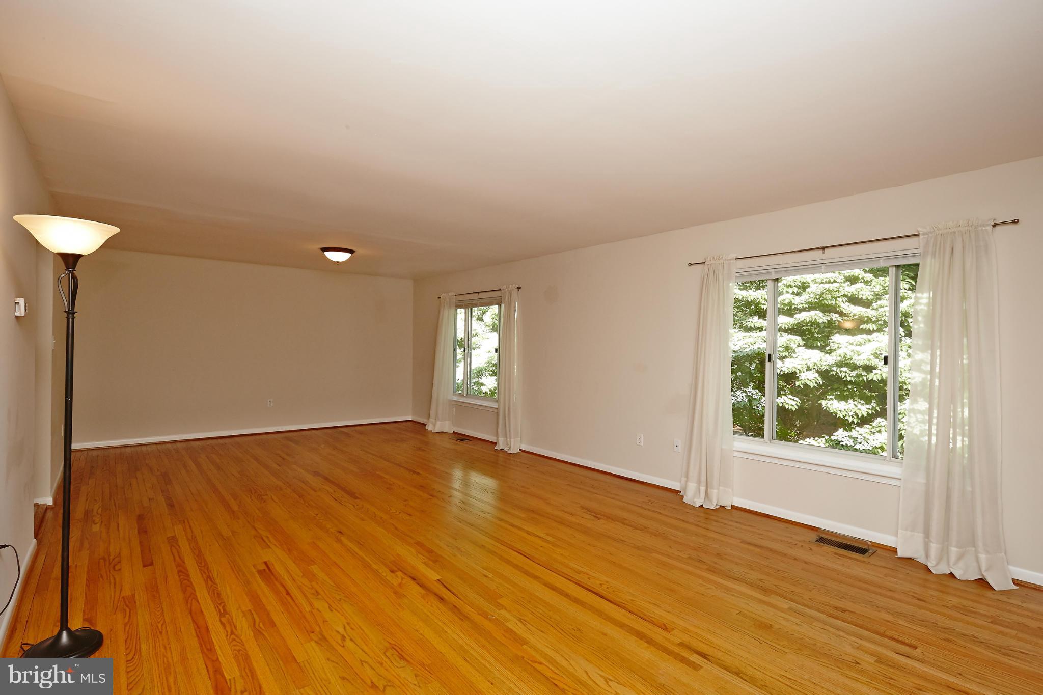 1426 Yellowwood Court Reston, VA 20190 - Photo 6 of 30 a view of an empty room with wooden floor and a window
