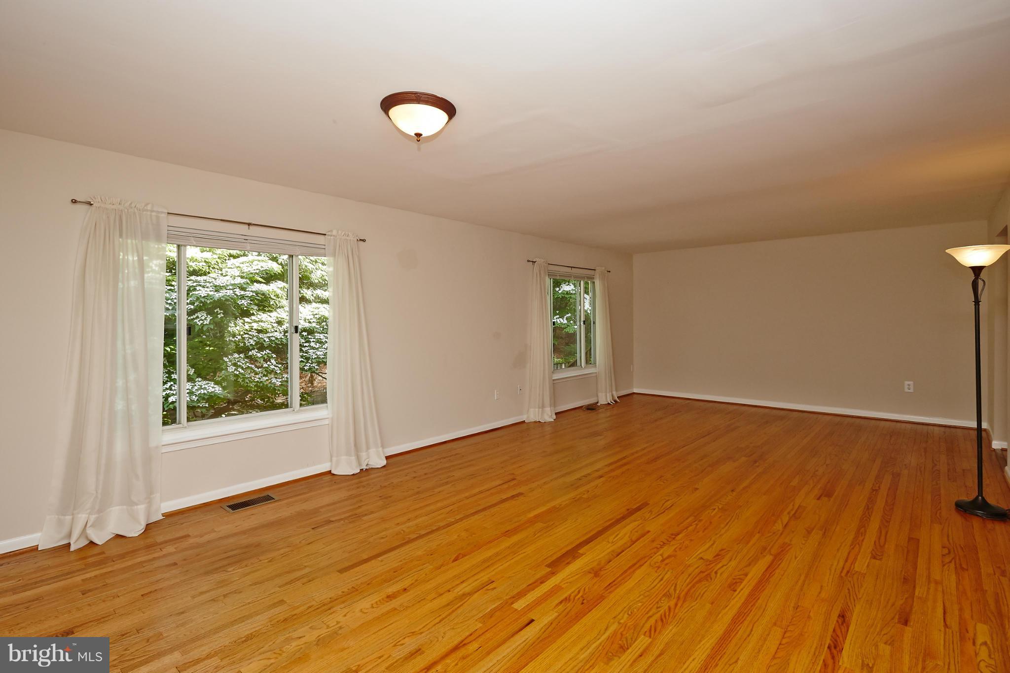 1426 Yellowwood Court Reston, VA 20190 - Photo 7 of 30 a view of empty room with wooden floor and fan