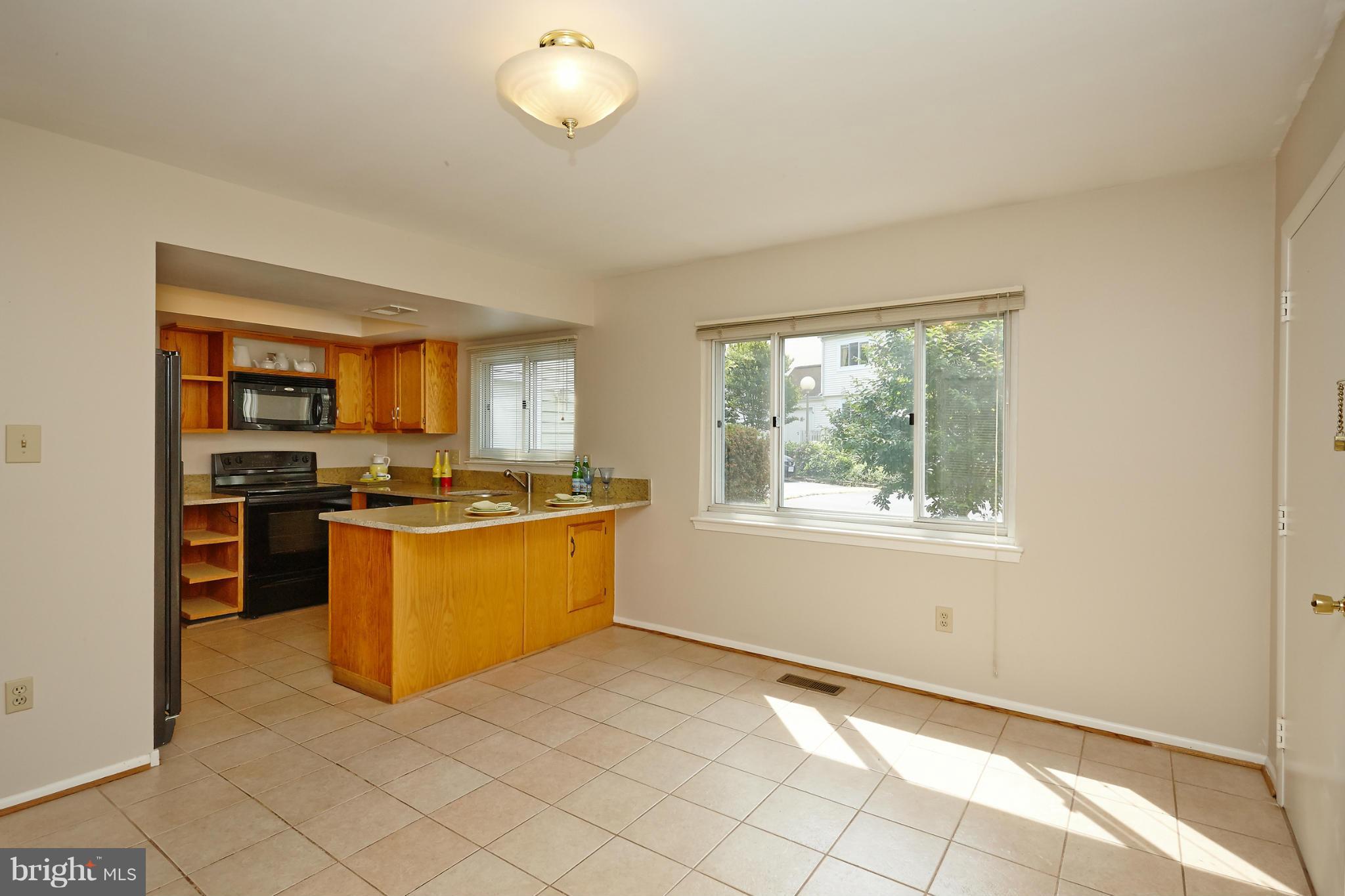 1426 Yellowwood Court Reston, VA 20190 - Photo 9 of 30 a large kitchen with cabinets appliances and a window