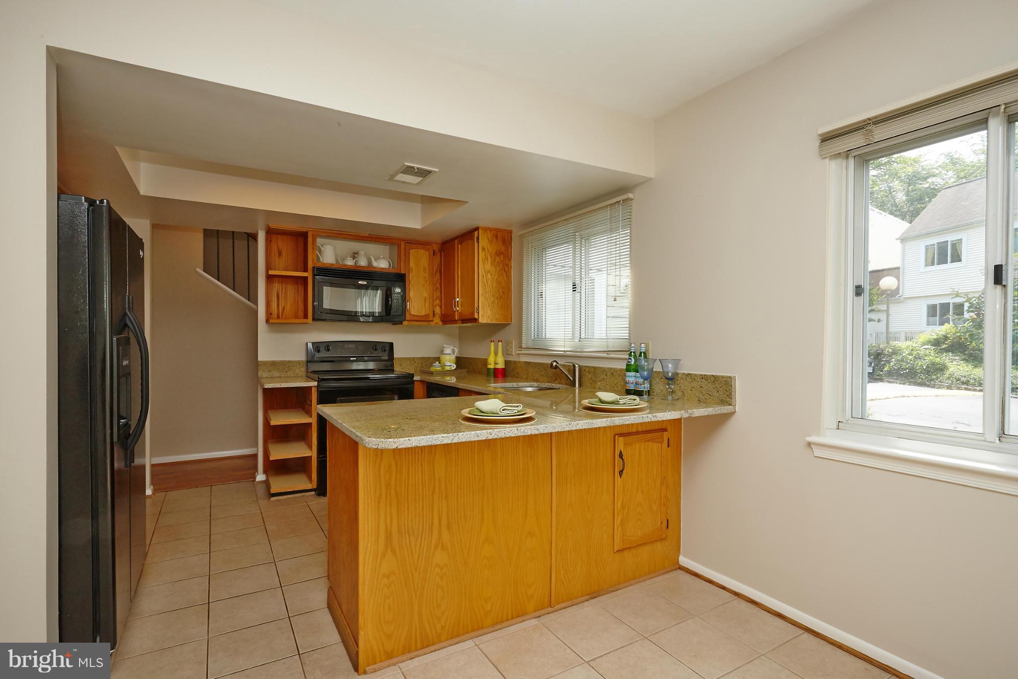 1426 Yellowwood Court Reston, VA 20190 - Photo 10 of 30 a kitchen with stainless steel appliances granite countertop a sink stove and refrigerator