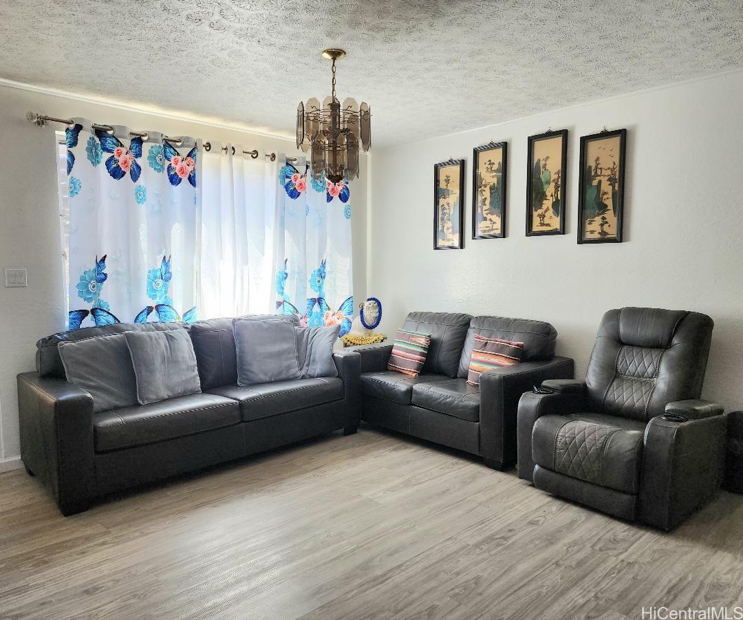 1638 Makamua Street Pearl City, HI 96782 - Photo 7 of 7 a living room with furniture and a chandelier