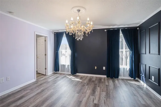 a view of entryway with chandelier and wooden floor