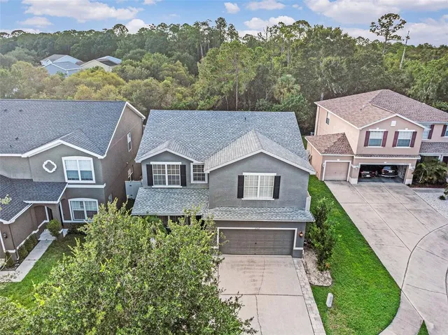 an aerial view of a house with a yard