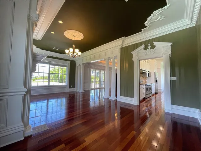 a kitchen with stainless steel appliances granite countertop a stove and a wooden floors