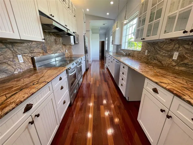 a stove top oven sitting inside of a kitchen