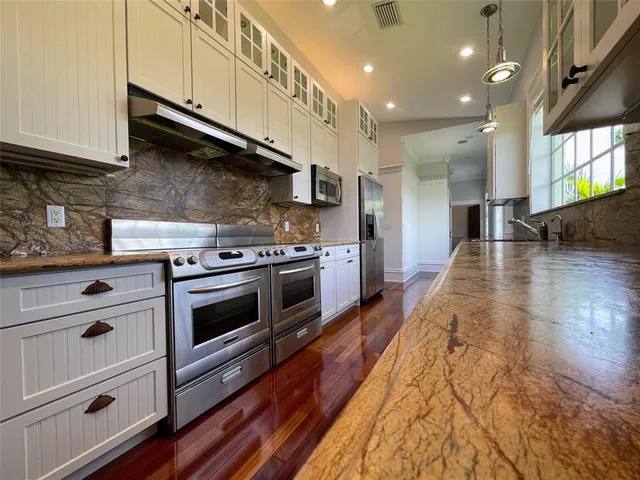 a view of a room with wooden floor