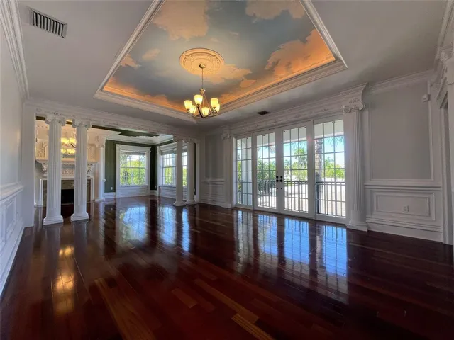 a living room with a fireplace and wooden floor