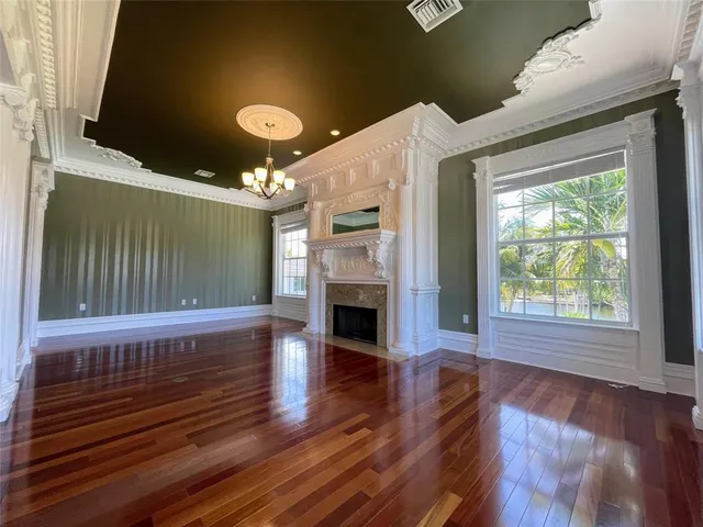 a view of a livingroom with furniture a fireplace and wooden floor