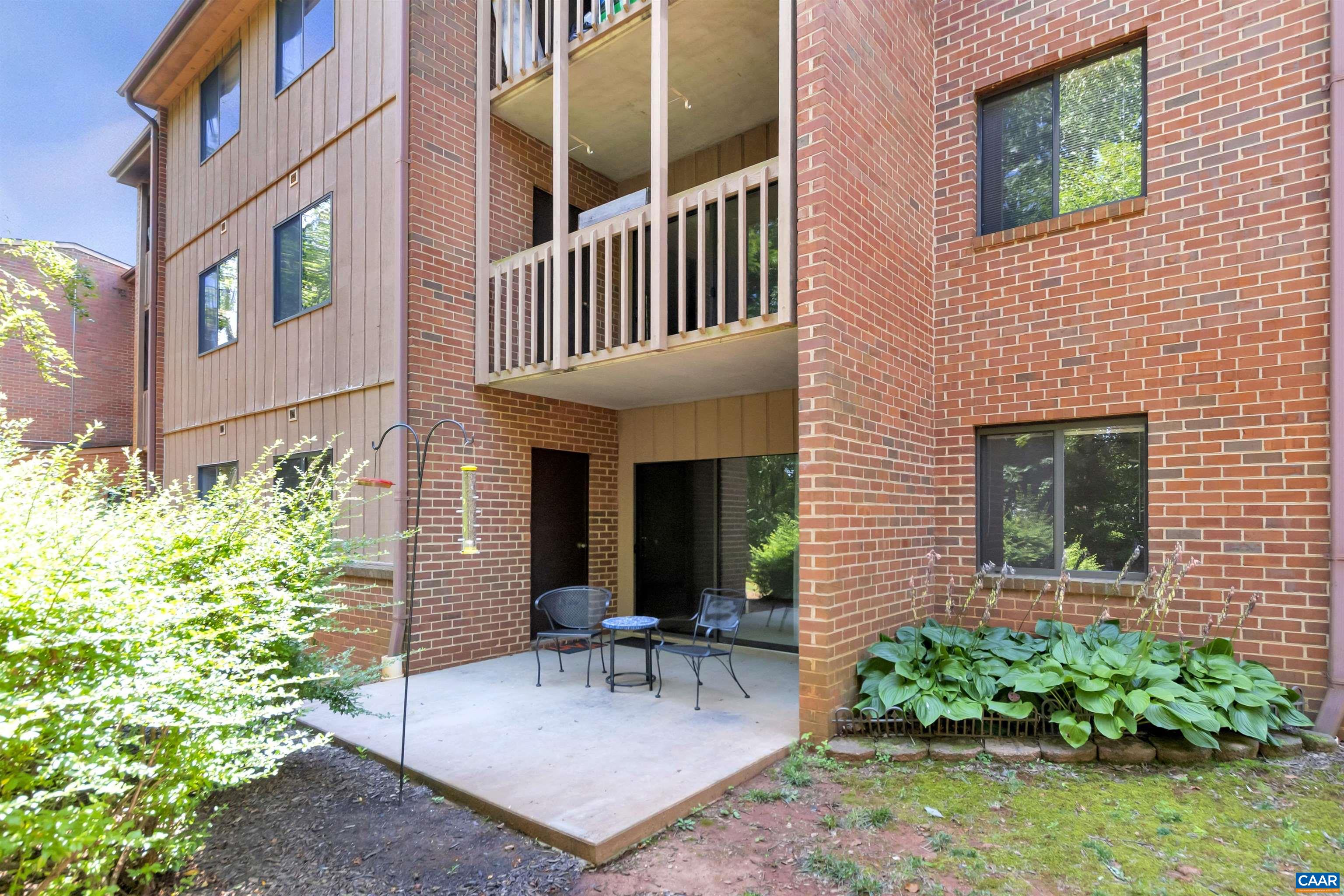 125 Turtle Creek Road, Unit 2 Charlottesville, VA 22901 - Photo 12 of 33 a view of a house with a chairs and table in a patio