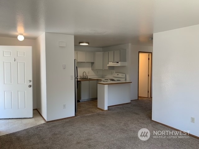808 Main Street Sultan, WA 98294 - Photo 7 of 13 a kitchen with a refrigerator and window