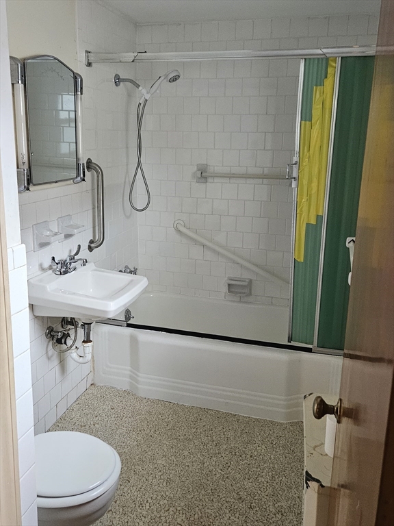 49 Sparks Street Lowell, MA 01854 - Photo 11 of 27 a bathroom with a sink a toilet and shower