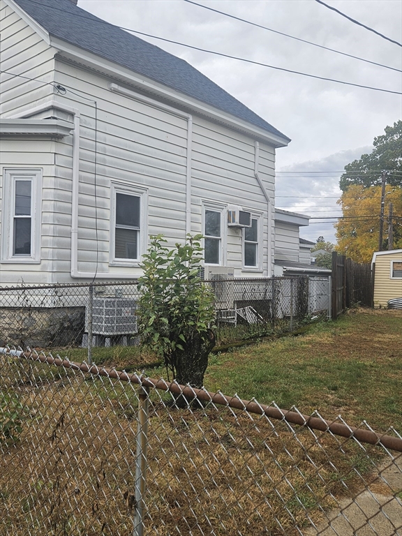 49 Sparks Street Lowell, MA 01854 - Photo 2 of 27 a view of a backyard with plants and large tree
