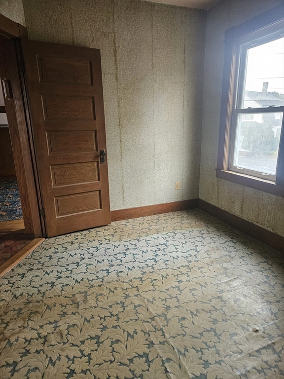 49 Sparks Street Lowell, MA 01854 - Photo 21 of 27 a room with a wooden door and a window