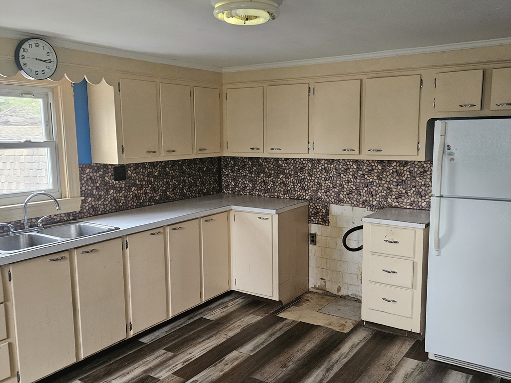 49 Sparks Street Lowell, MA 01854 - Photo 4 of 27 a kitchen with white cabinets and window