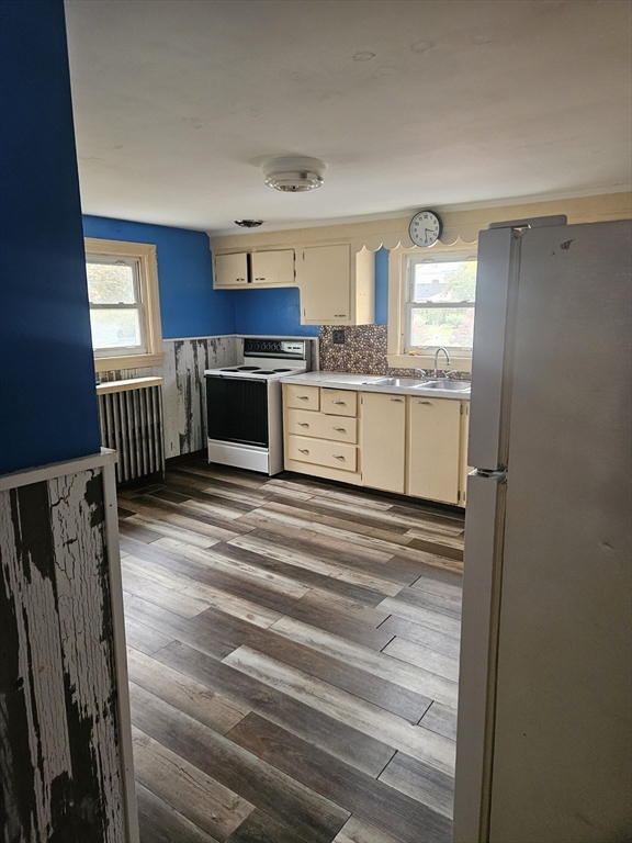 49 Sparks Street Lowell, MA 01854 - Photo 6 of 27 a kitchen with cabinets and window