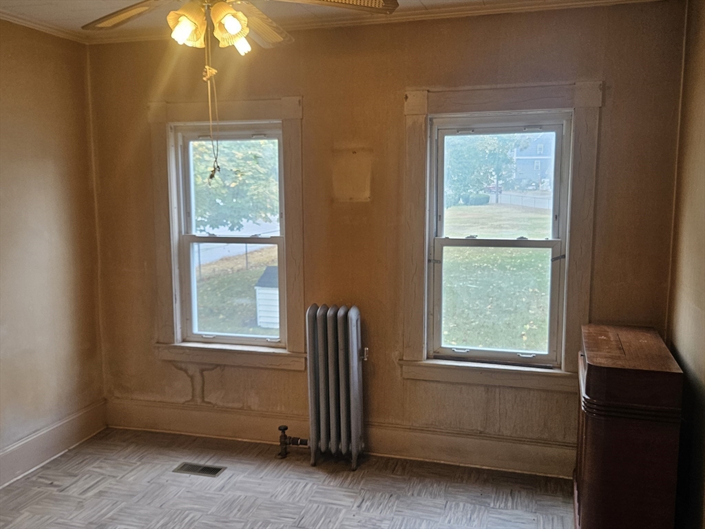 49 Sparks Street Lowell, MA 01854 - Photo 10 of 27 an empty room with windows and closet