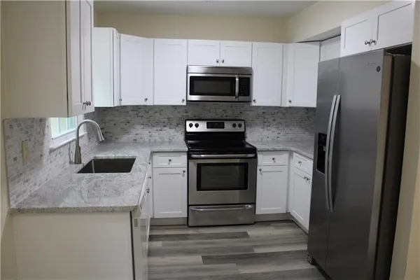 a kitchen with a stove microwave and refrigerator