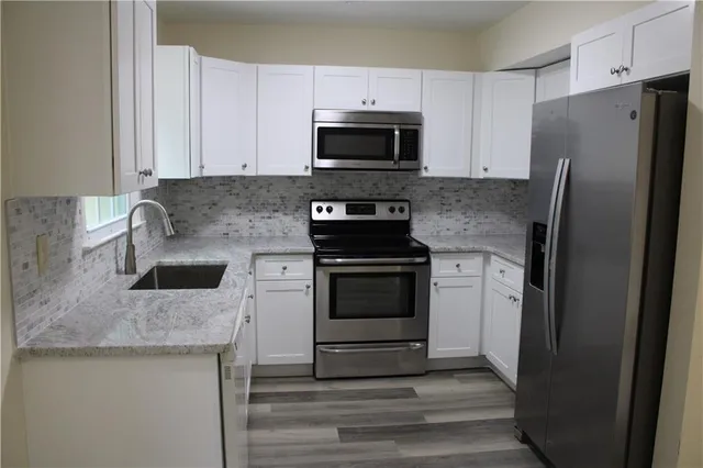 a kitchen with a stove microwave and refrigerator