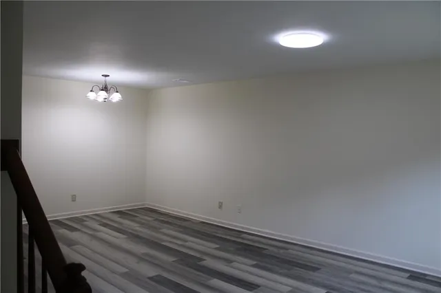 a view of a room with wooden floor and fan