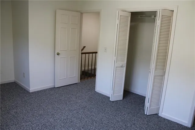 a view of a closet area with ceiling fan